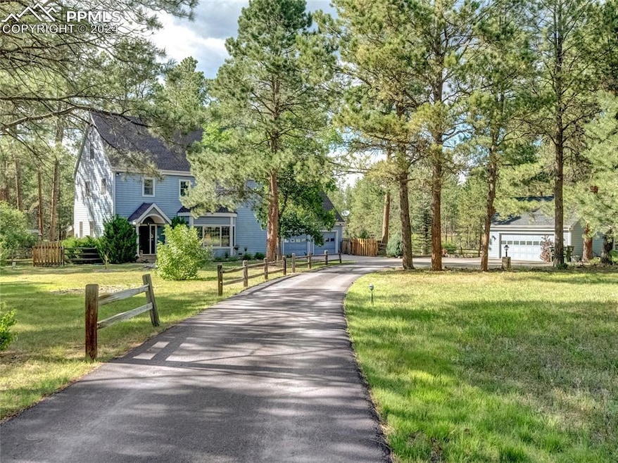 View of home's community with a lawn and a garage