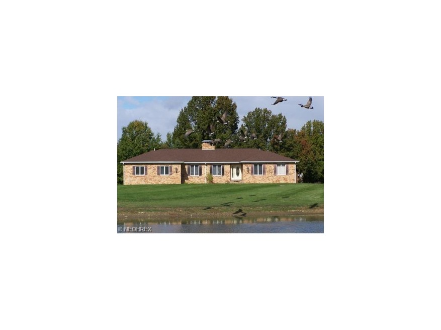 Beautiful brick ranch with pond out front