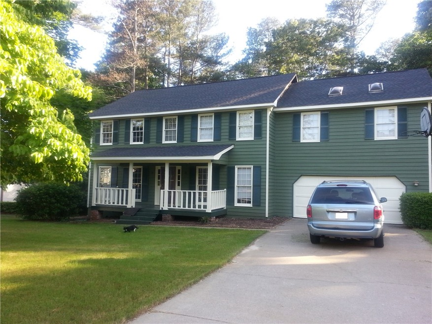 front view of home with swinging covered porch lev