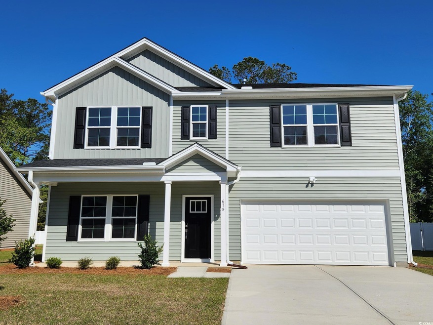 Traditional-style home with a garage, covered porc