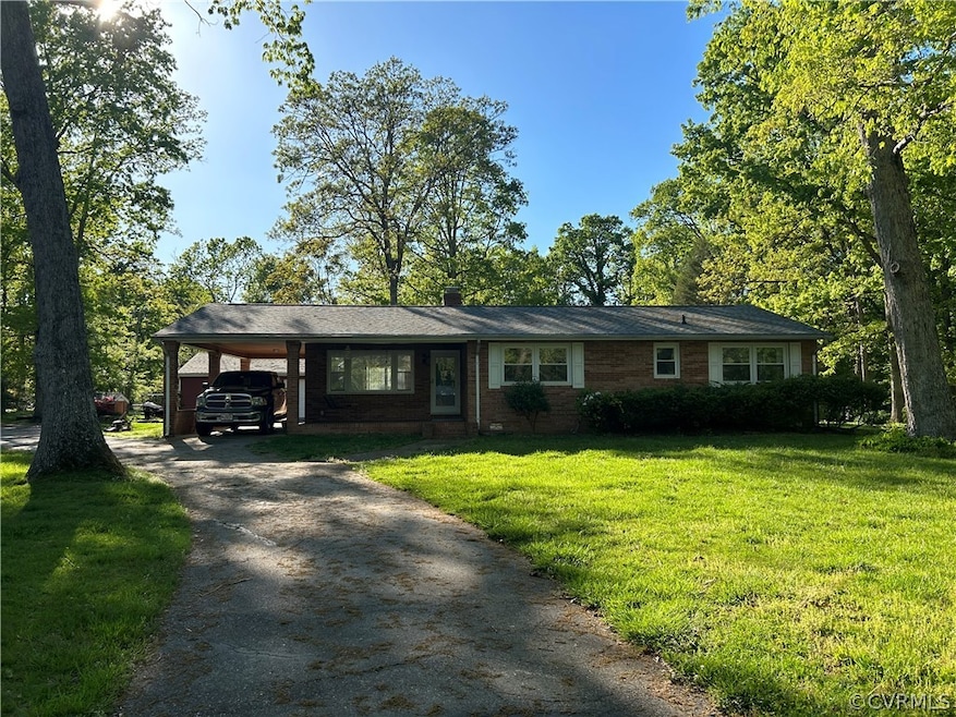 Single story home featuring a carport and a front