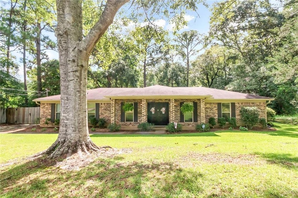 Single story home featuring a front lawn