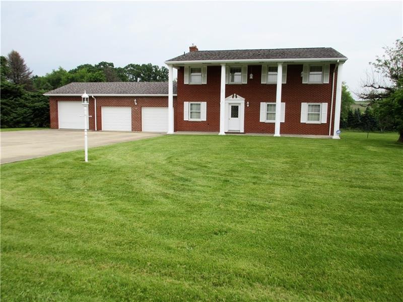 Colonial style home with a 3 car attached garage.