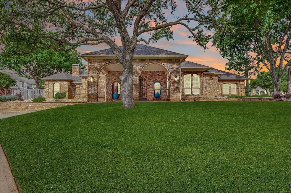 Front of home with porte-cochère and circular driveway