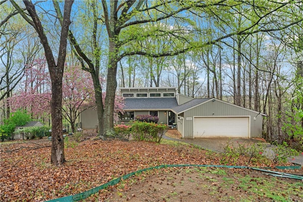 Mid-century modern home with driveway, a garage, a