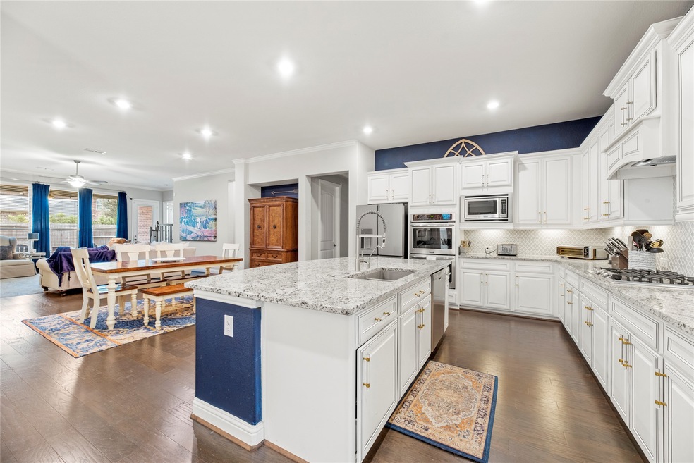 The oversized center island beautifully frames the kitchen, where you can add your bar stools for additional breakfast bar seating.