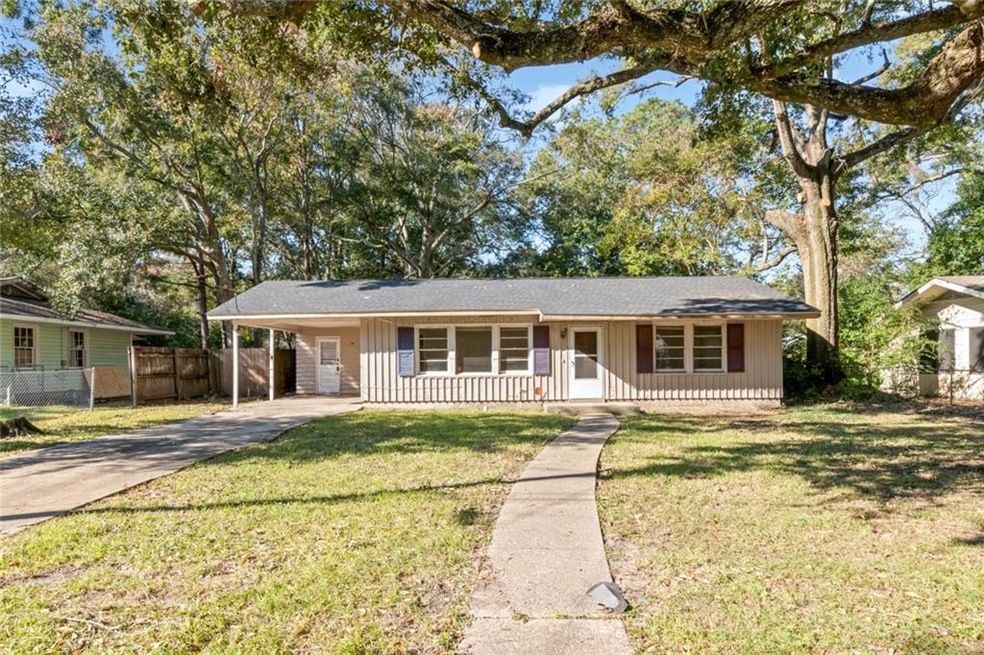 Single story home with a front lawn, covered porch