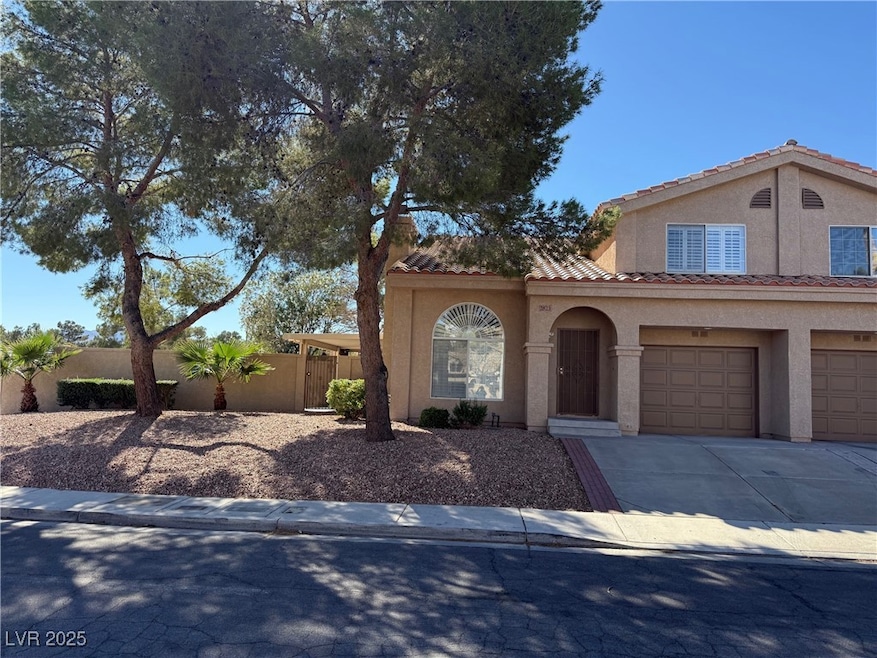 Mediterranean / spanish home featuring stucco siding, driveway, an attached garage, and a tiled roof
