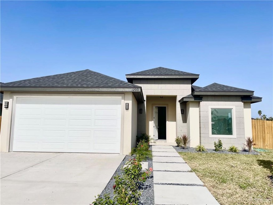 Prairie-style house featuring a garage and a front lawn