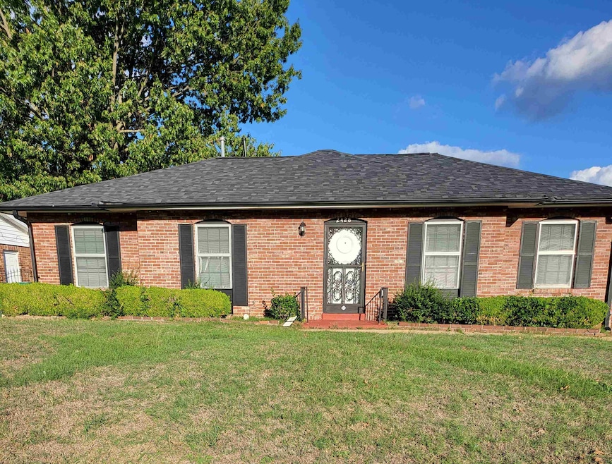 Single story home featuring a front lawn