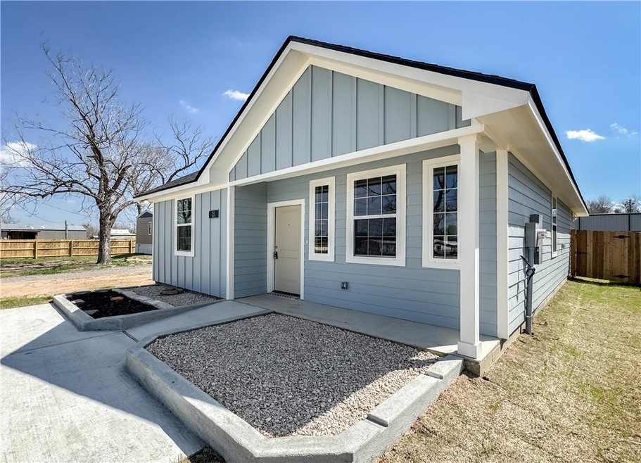 View of front of house featuring a patio, board an