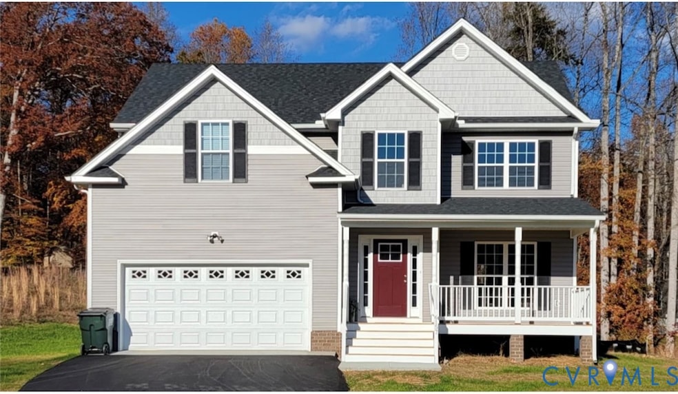 View of front facade with covered porch, driveway, a garage, and a shingled roof