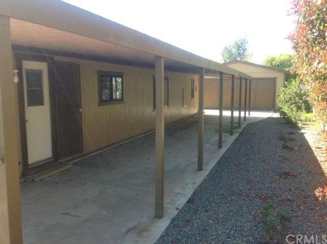 Carport that leads to 2 car detached garage.