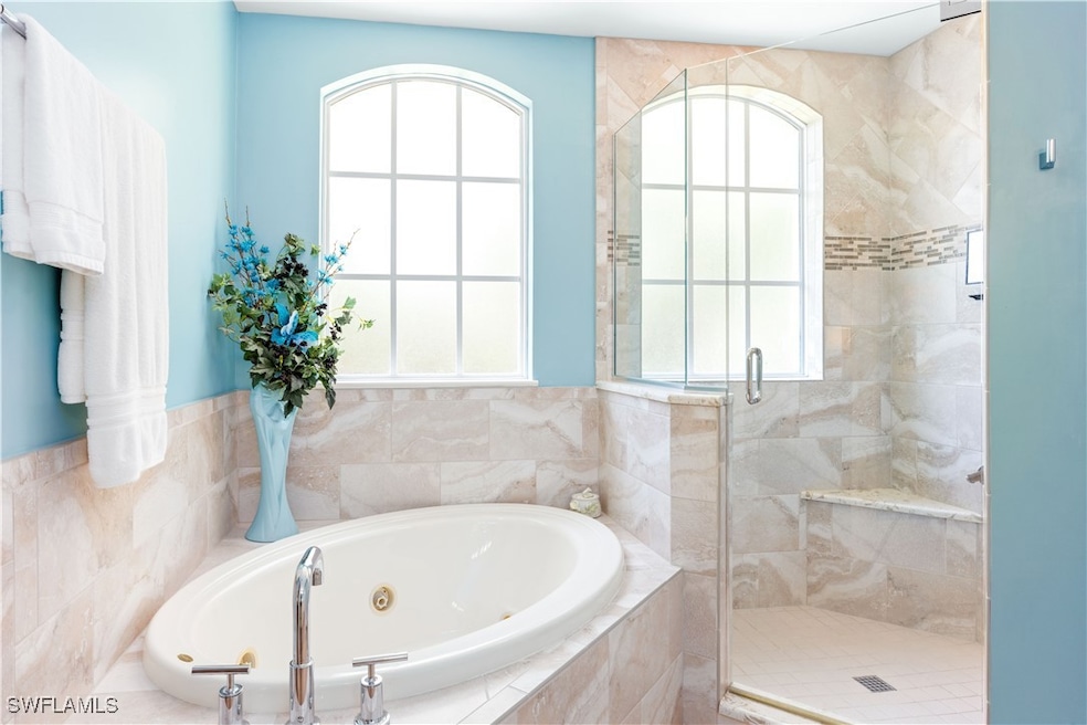 Full bathroom featuring a shower stall, a whirlpoo