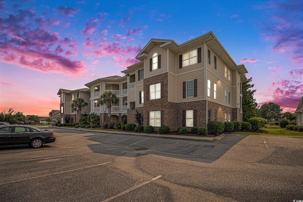 Property at dusk featuring uncovered parking