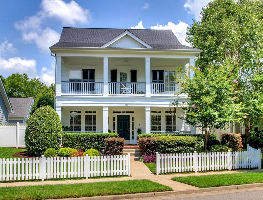 Double front porches and a white picket fence welcome you home to 308 Sundance Ln!