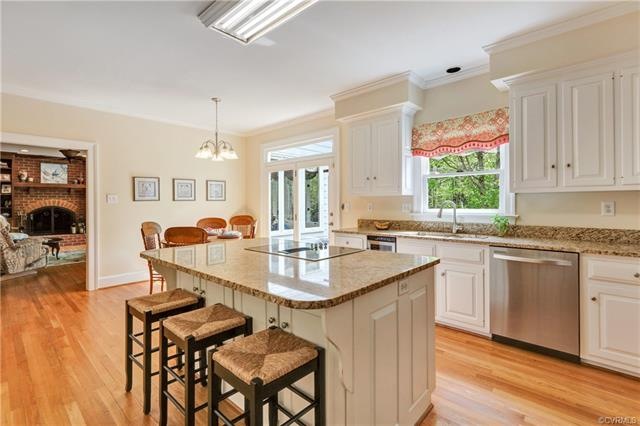 Spacious eat-in kitchen with hardwood floors, center island with granite and french door to oversized deck!