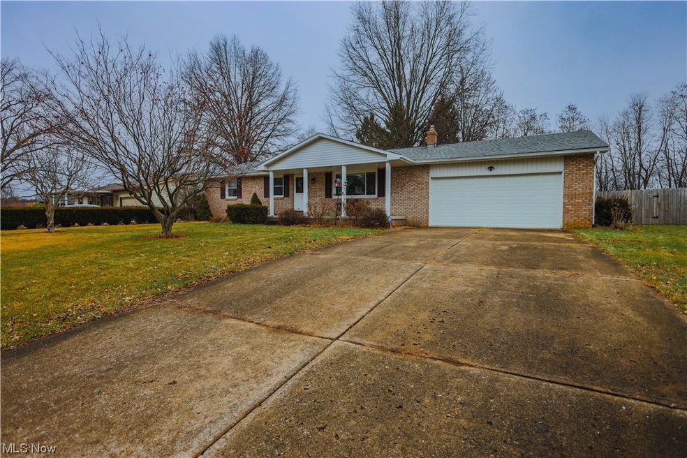 Single story home featuring a front lawn and a garage