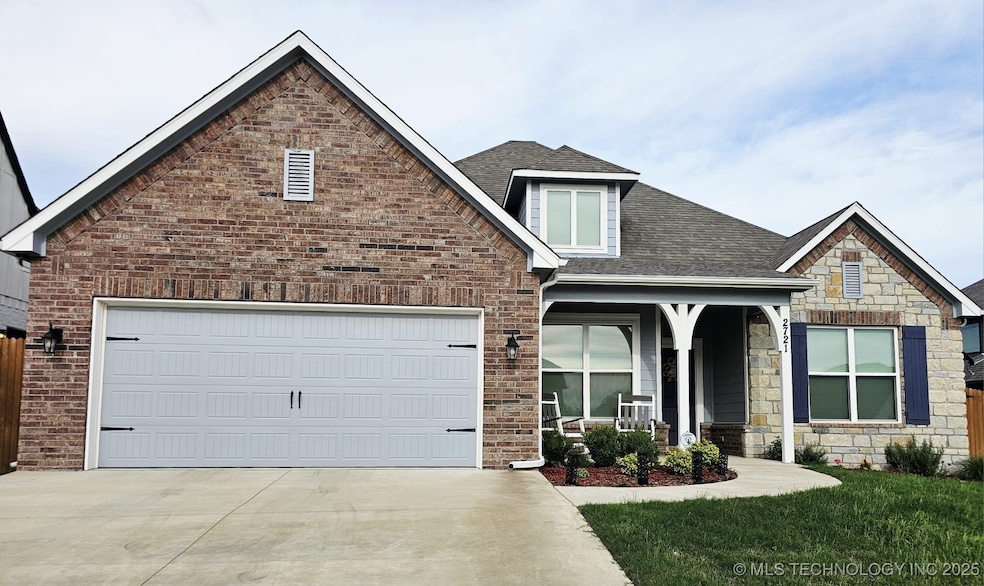 View of front of home featuring roof with shingles, a porch, driveway, a garage, and brick siding