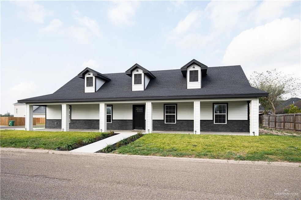 View of front of property featuring a porch and a shingled roof