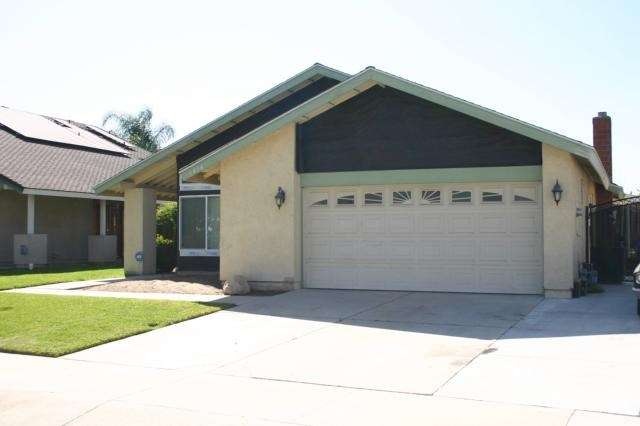 Front view.  Stucco above garage door and at roof 