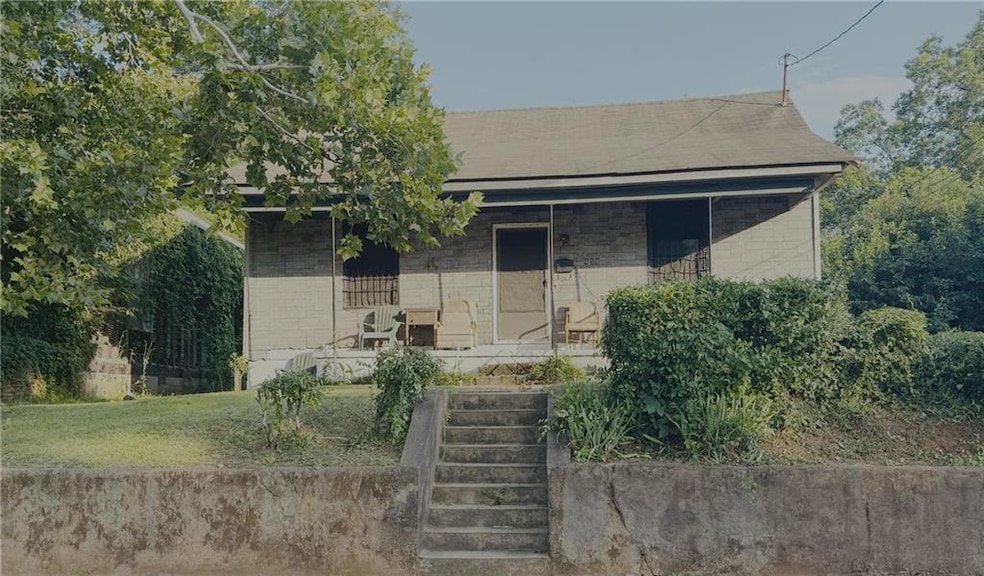 View of front of property with a porch and brick siding