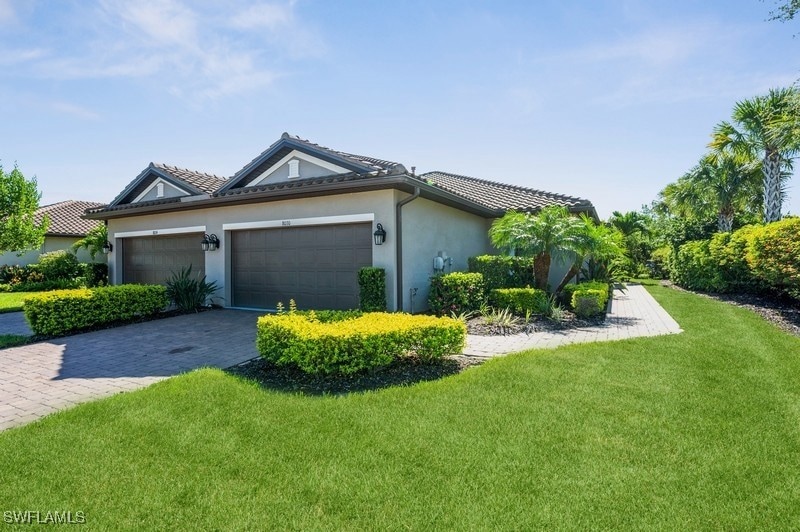 View of side of property with a yard, stucco sidin