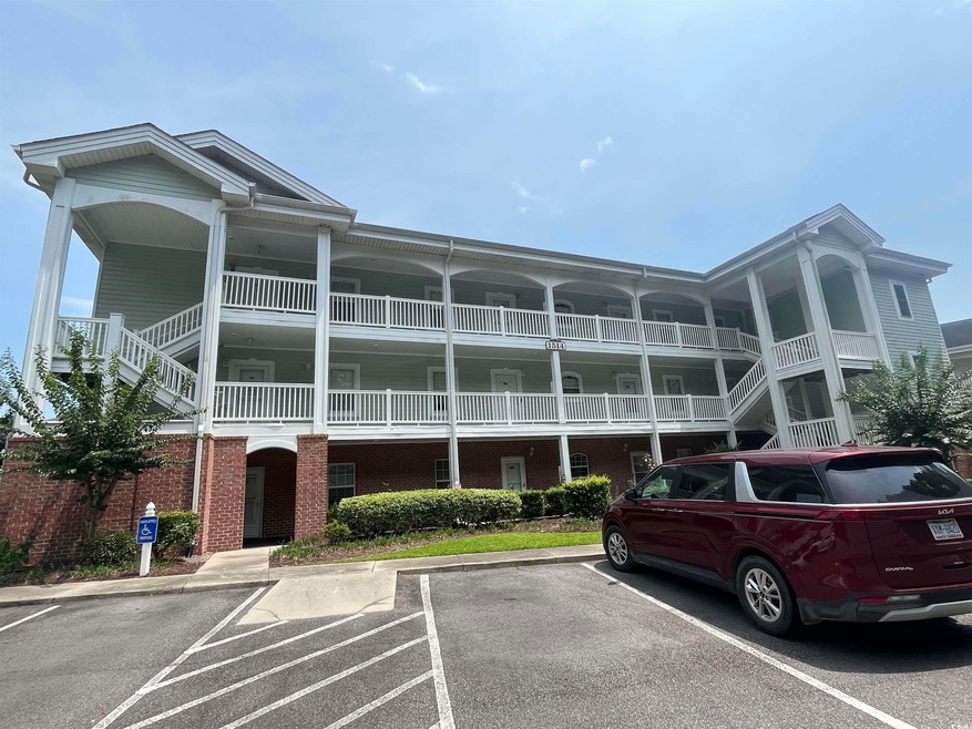 View of property with uncovered parking