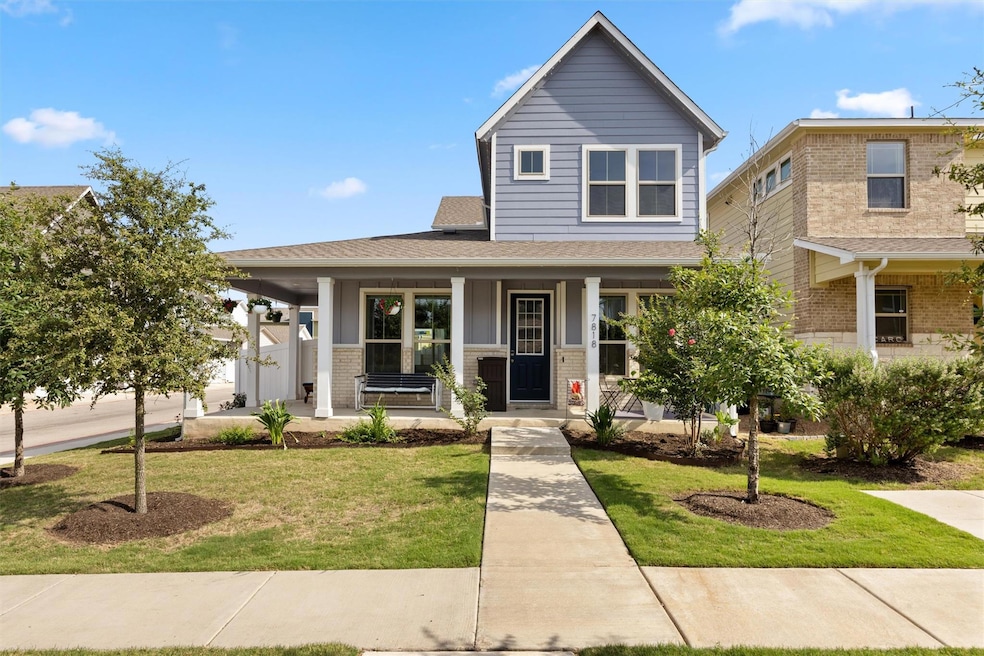 View of front facade with a porch, brick siding, 