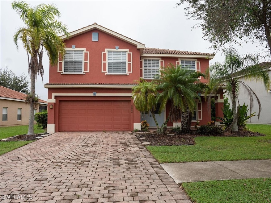 View of front of house with stucco siding, a garage, decorative driveway, and a tiled roof