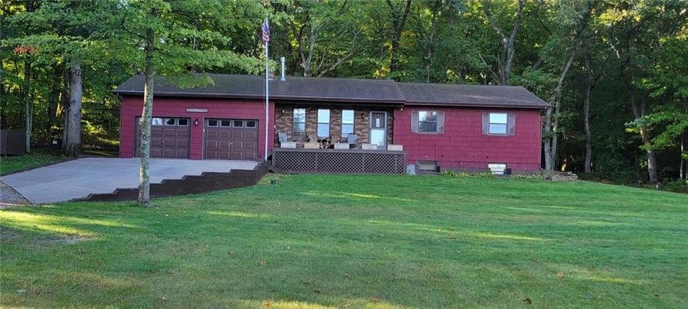 Home nestled in the woods with Hardboard siding an
