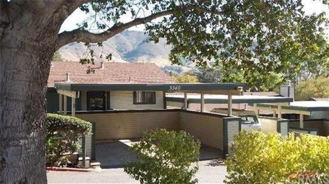 Two car carport with condo unit behind.