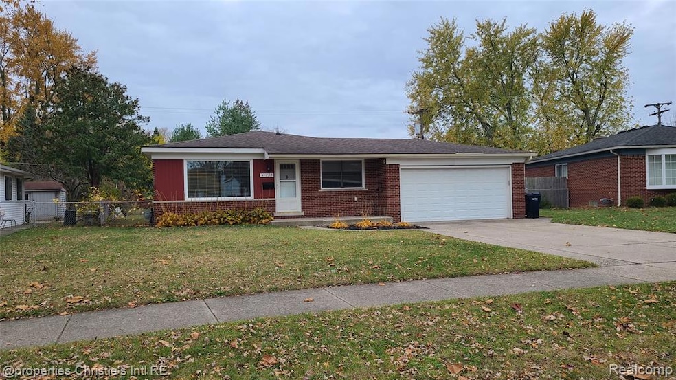 View of front of property with brick siding, driveway, an attached garage, and a shingled roof