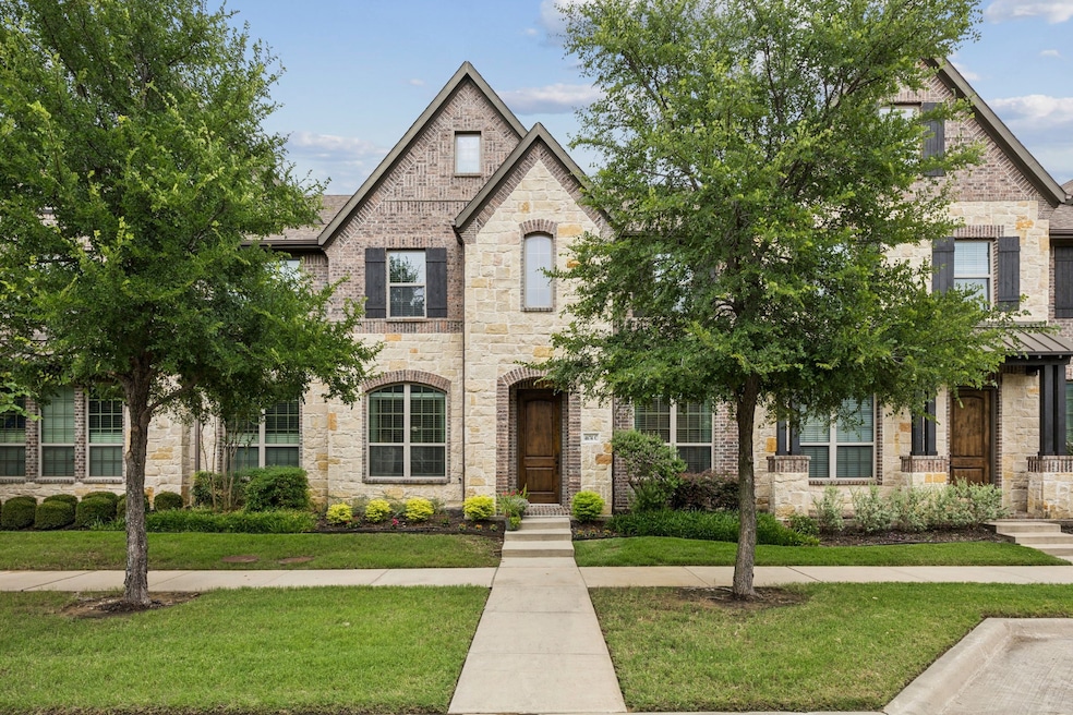 View of front of home featuring stone siding and a front yard