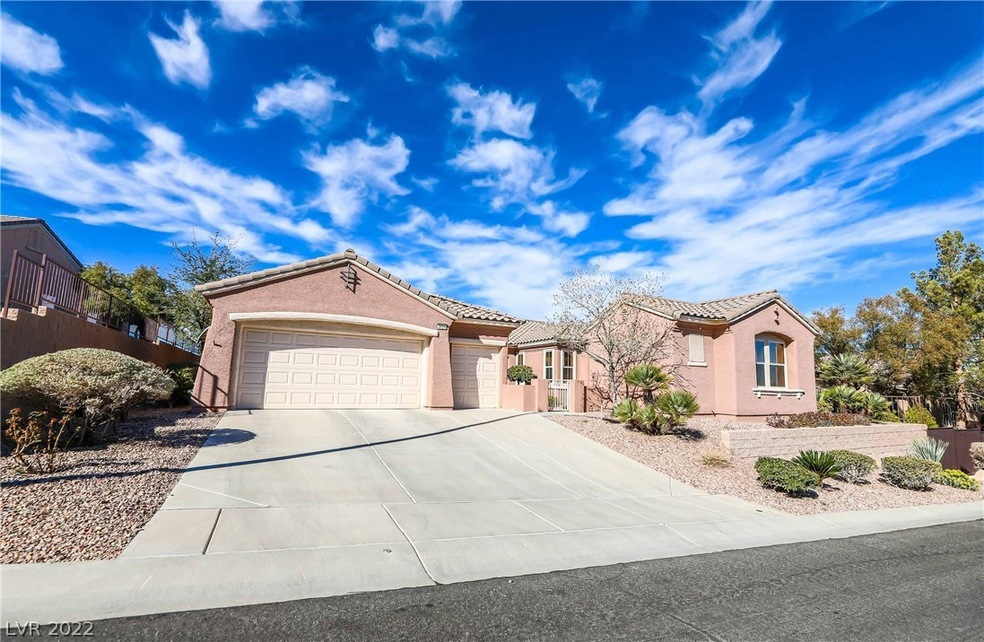 View of the wide driveway, two car garage, golf ca