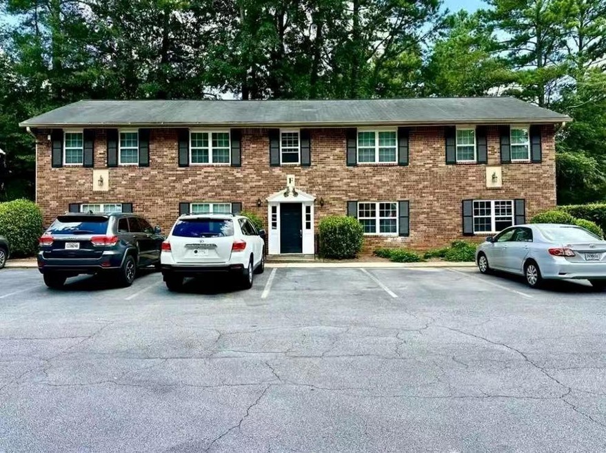 View of front of property featuring uncovered parking and brick siding