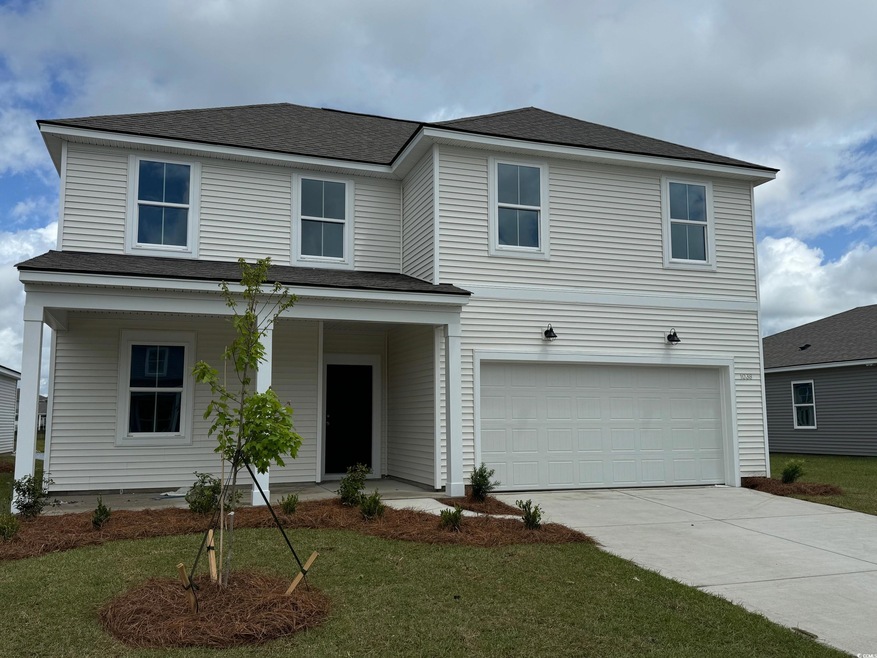 Traditional home with an attached garage, concrete