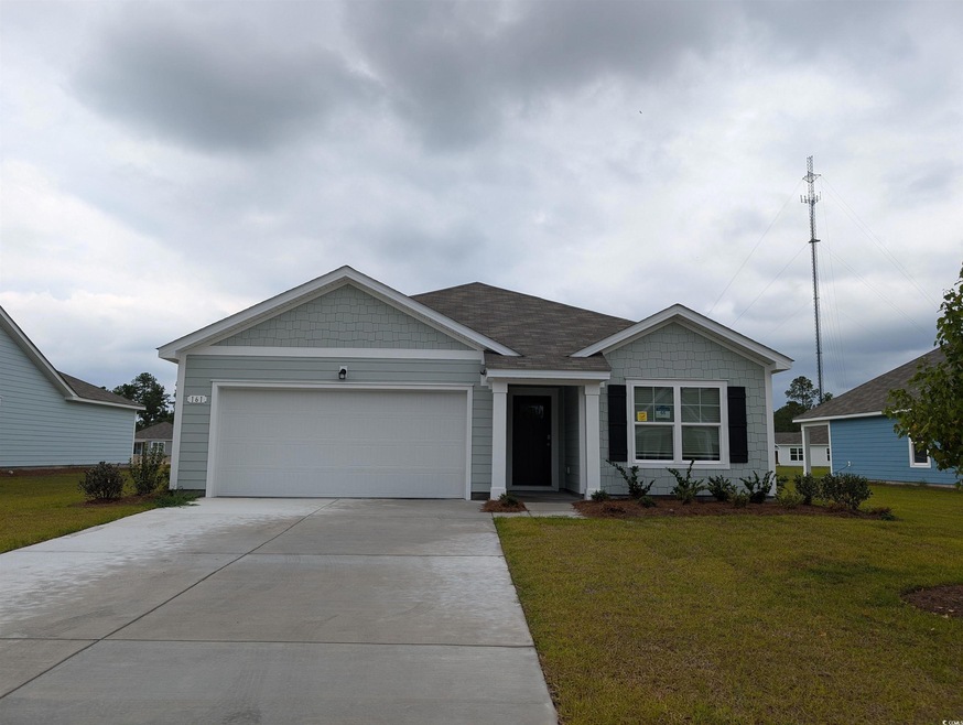 Ranch-style house featuring a garage and a front y
