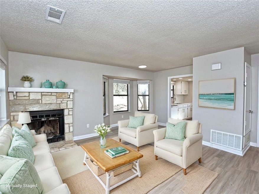 Living area with visible vents, light wood-type f