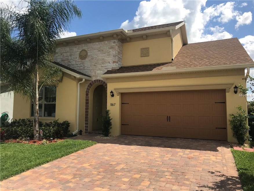 The front of the home features stacked stone and a