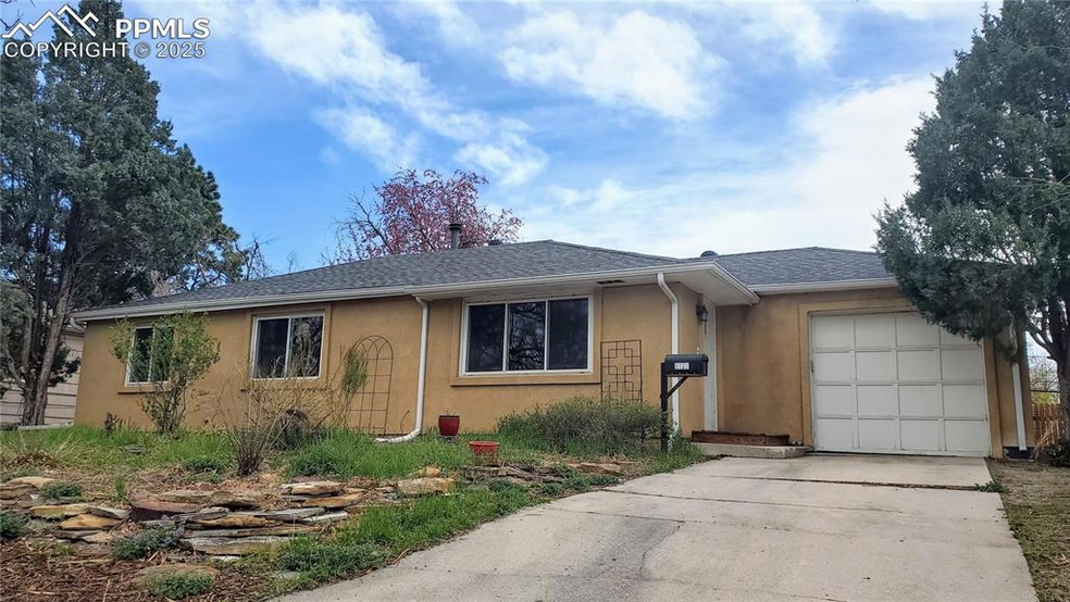 Ranch-style home featuring roof with shingles, an attached garage, driveway, and stucco siding