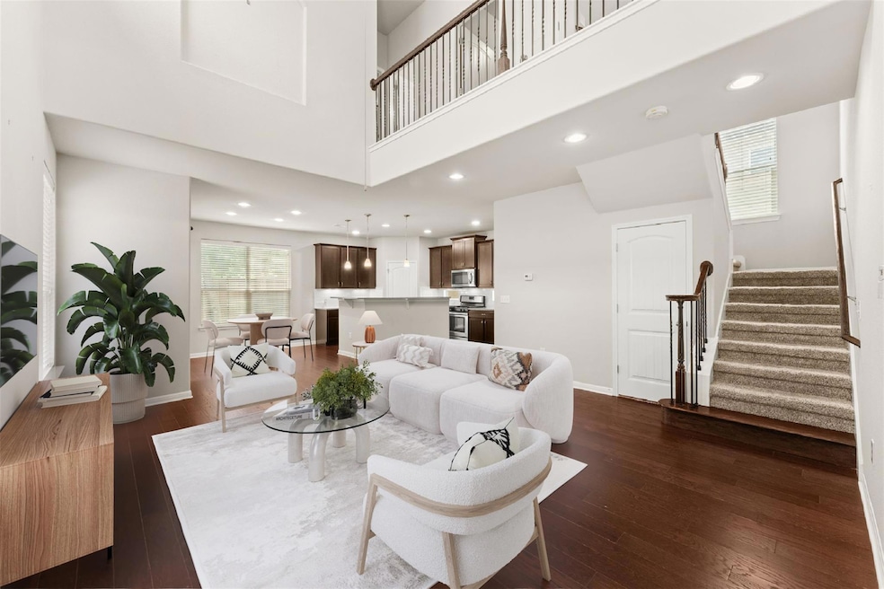 Living room featuring stairs, dark wood-style flo
