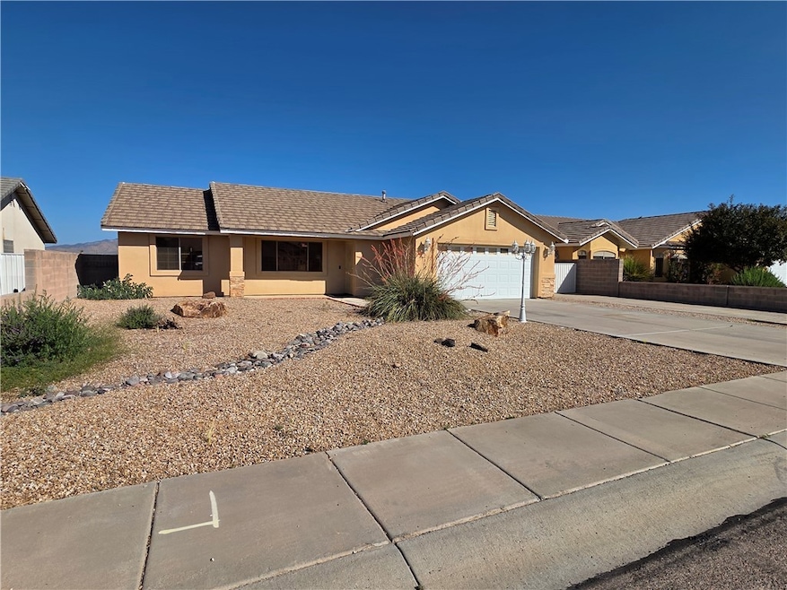 Ranch-style home featuring a garage, driveway, and