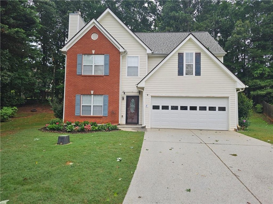 Traditional-style home with concrete driveway, brick siding, a front yard, and a chimney