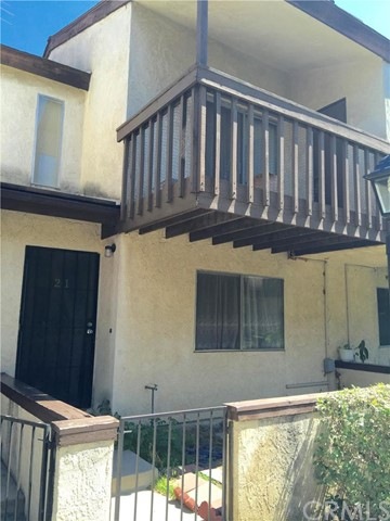Front of Unit with an Upstairs Balcony