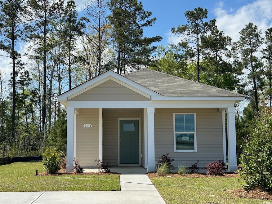 Bungalow featuring roof with shingles, a front yar
