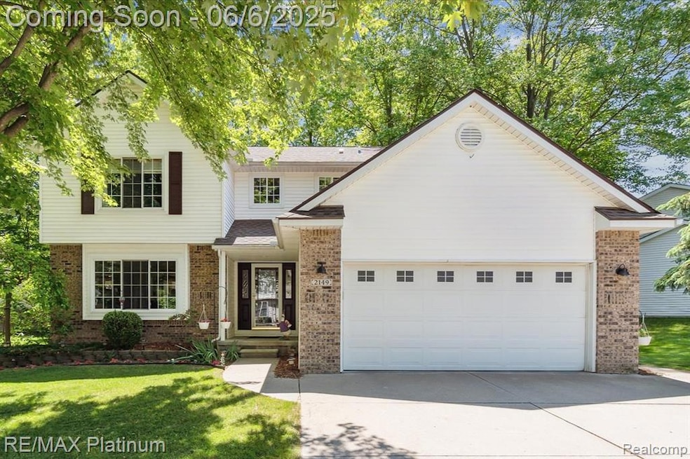 Picture-perfect curb appeal with fresh landscaping, mature trees, and a sunny welcome home vibe.