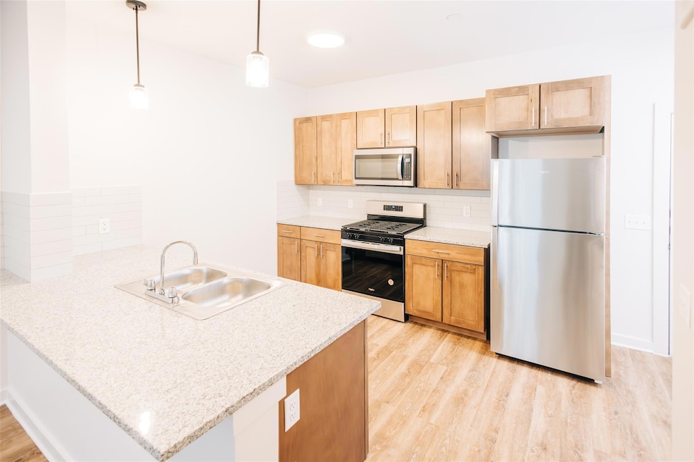 Kitchen featuring stainless steel appliances, a s
