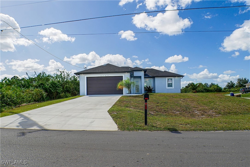 View of front of house with a garage and a front l