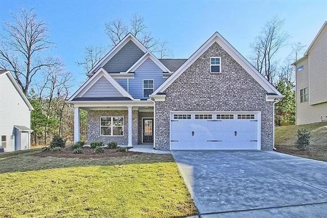 View of front facade featuring concrete driveway, 
